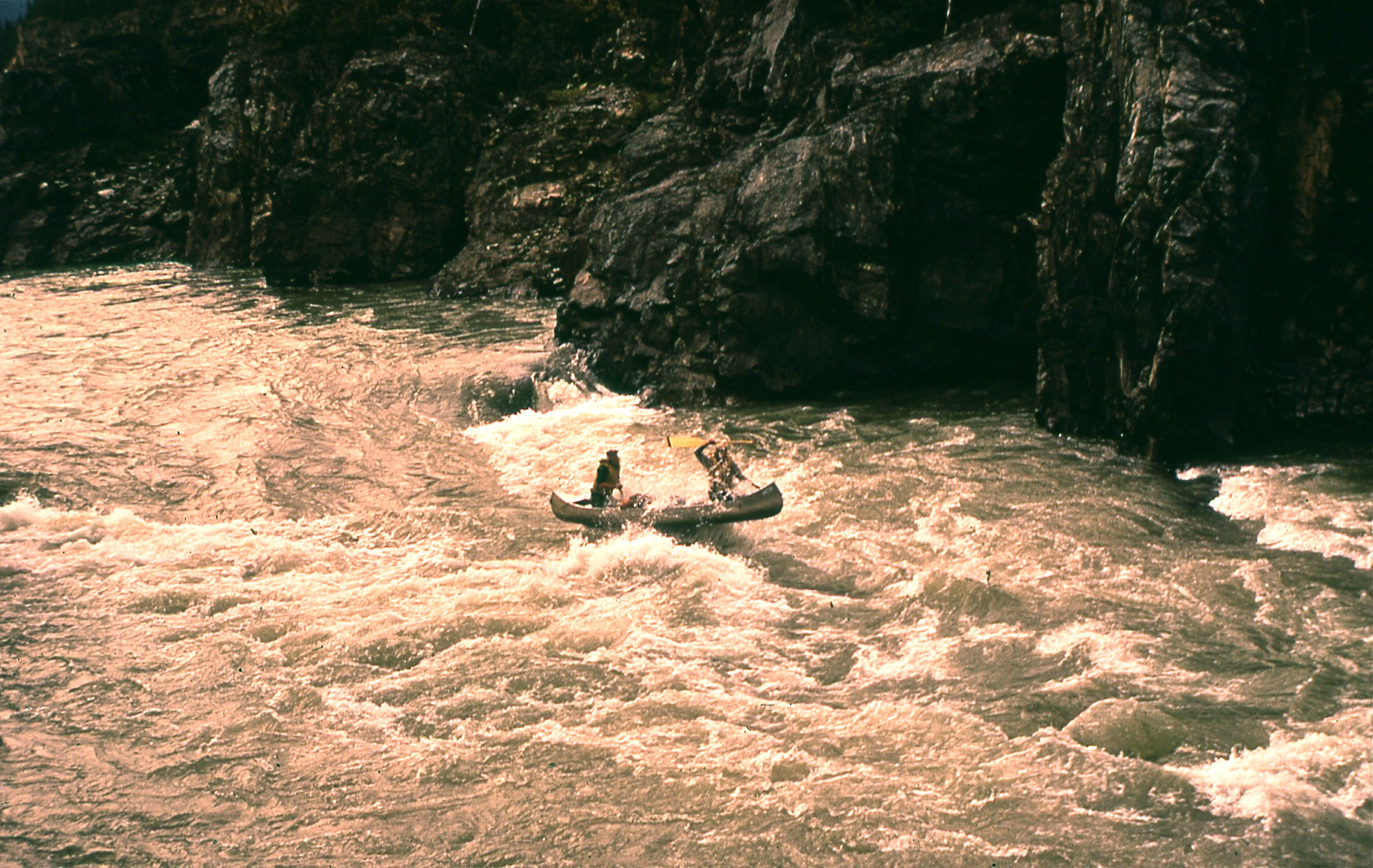 Both ends of the canoe out of the water on the Liard River in 1973.