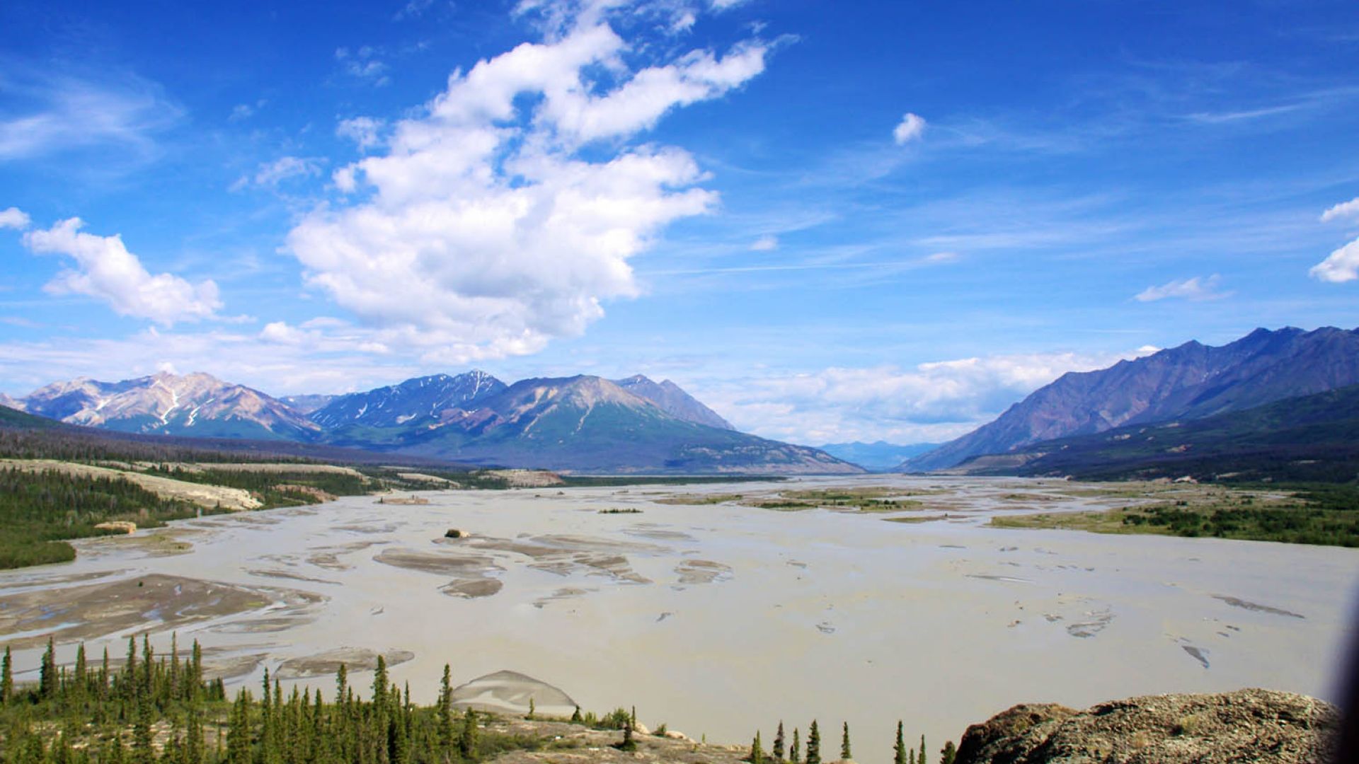 Silt-laden waters of the Upper Alsek River with the St. Elias Mountains in the background