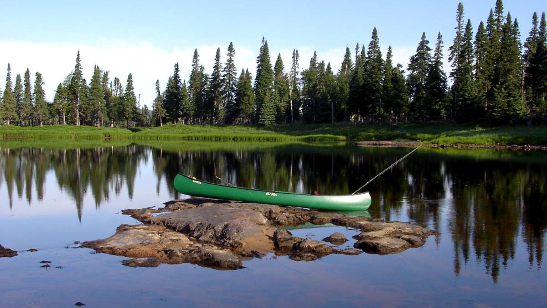 A canoe parked for fishing on a shallow, rocky section of the Main River.