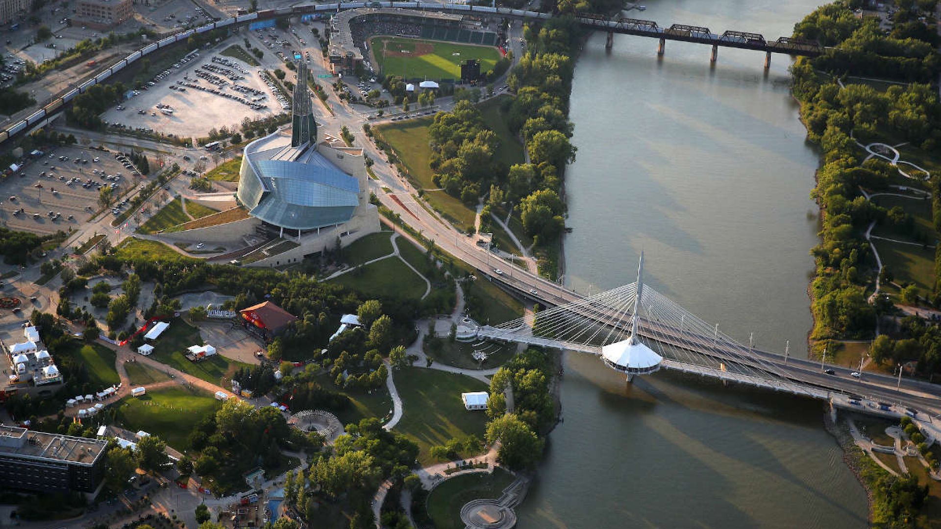 A bird's eye view of downtown Winnipeg, centered on the Esplanade Riel crossing the Red River and the Canadian Museum for Human Rights. (Photo: George Fischer Photography)