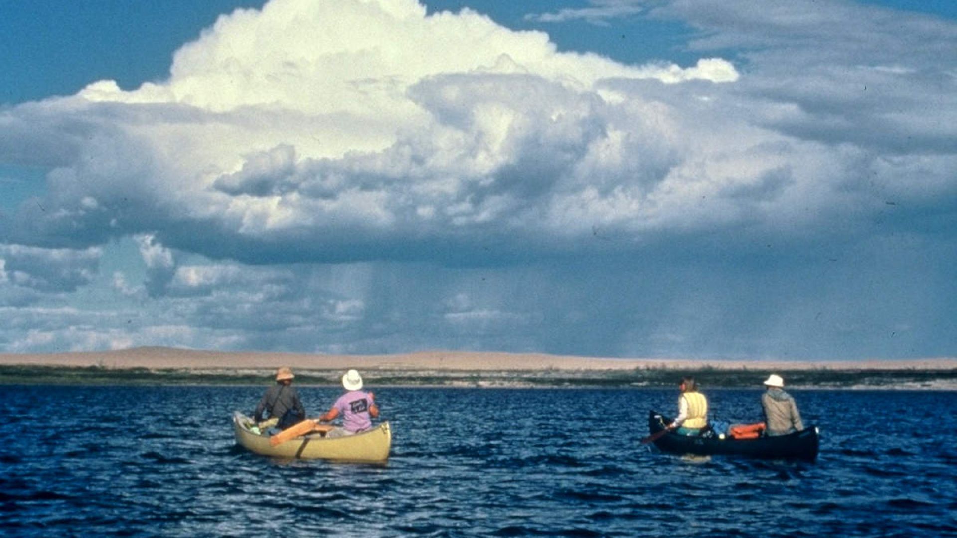 Paddlers in two canoes float on the Thelon River. 