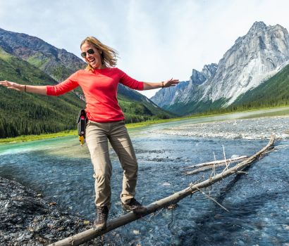 Walking on a log in Nahanni National Park Reserve 